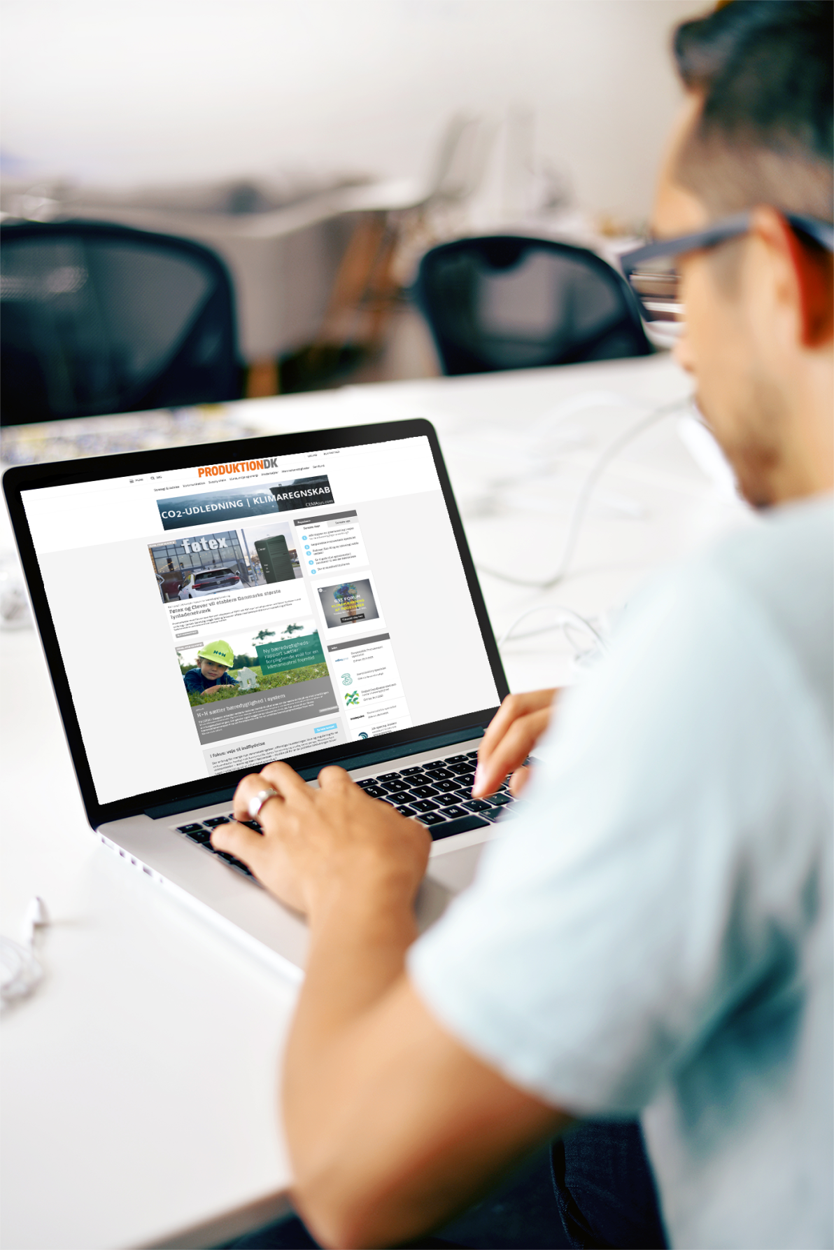 Whitney leaning against a railing on a downtown street